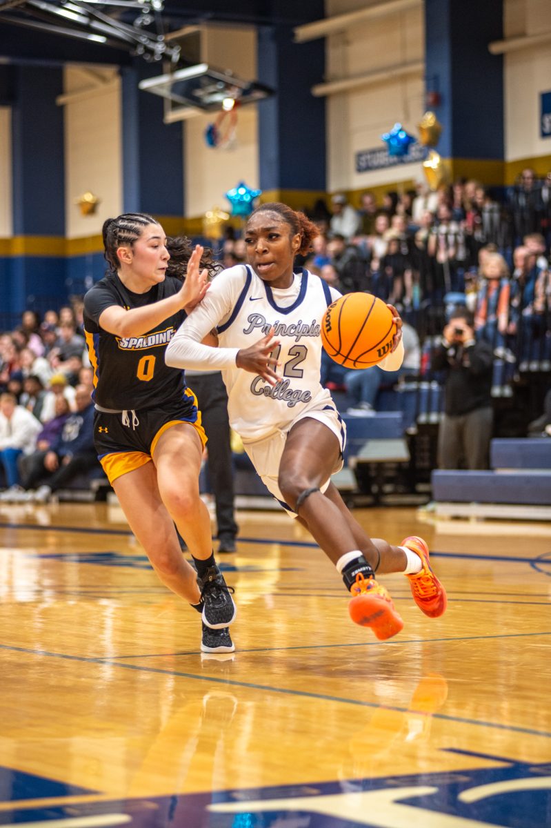 Junior Ari Williams pushes past a Spalding player in a home game in Hay Field House, Principia College. Williams earned SLIAC all defensive team for the 2023-24 season